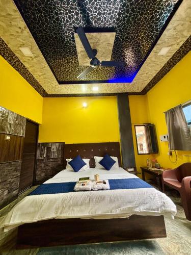a bedroom with a bed with a ceiling fan at Amber Palace in Varanasi