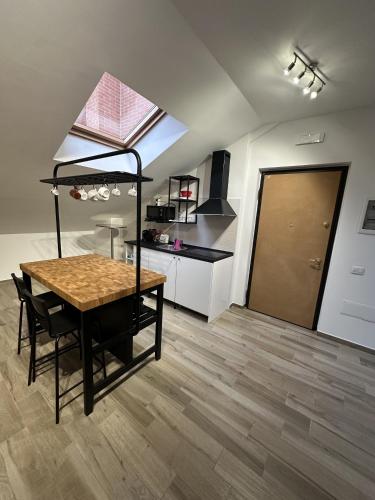 a living room with a table and a kitchen at La Villa - Il Loft in Frosinone