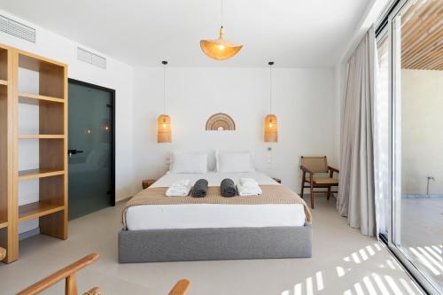 a bedroom with a bed with two shoes on it at Amore Luxury Villas Resort in Athani