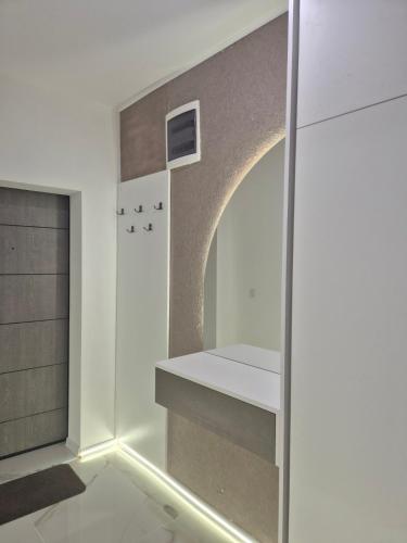 a room with a hallway with a wall with an arch at Апартамент Top Central in Yambol