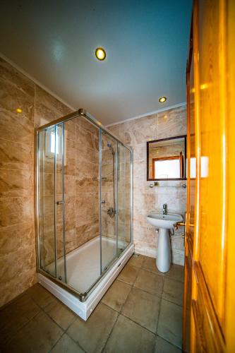 a bathroom with a shower and a sink at Nagi Beach Hotel in Gümbet