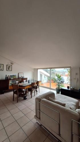 a living room with a couch and a table at L'Attico Affittacamere in Santa Maria degli Angeli
