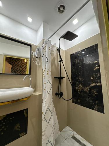 a bathroom with a shower curtain and a sink at Villa Romana in Bucharest