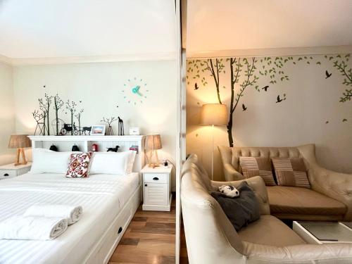a bedroom with a white bed and a couch at My Resort Condo in Hua Hin E204 in Hua Hin