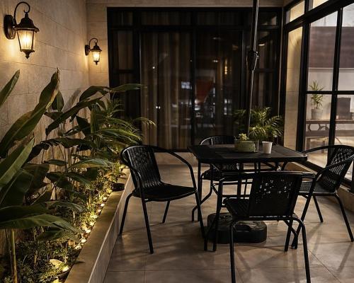a patio with a table and chairs and plants at Balai de Biday 4 Pax Suite with Breakfast Option in Mameltac