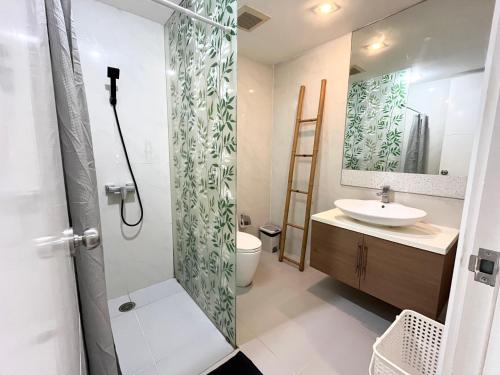 a bathroom with a shower and a toilet and a sink at My Resort Condo in Hua Hin E204 in Hua Hin