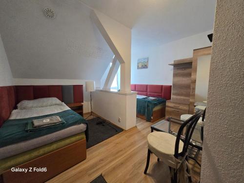 a bedroom with a bed and a chair in it at Bike Hostel&Camp in Przewóz