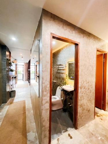 a bathroom with a sink and a toilet and a mirror at Island Pod in El Nido