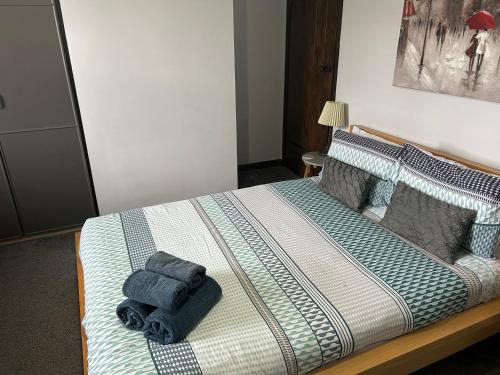 a bedroom with a bed with towels on it at Beach Retreat in Seahouses
