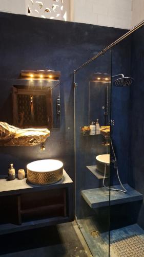 a bathroom with two sinks and a glass shower at Srikadhama in Udupi
