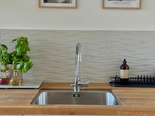 a kitchen sink with a faucet on a counter at Modern Seaside Guesthouse with Archipelago Views in Nacka