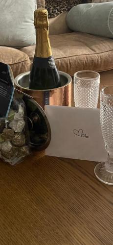a bottle of champagne and a box of wine at Number 78 Boutique M56 Junction 12 located 5 minutes drive from Frodsham Continental breakfast Included Entire accommodation comprises of a Large double bedroom Separate lounge with sky tv Large bathroom with a free standing bath and shower in Frodsham