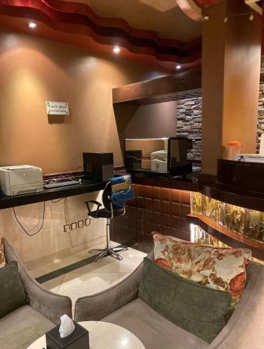 a restaurant with a waiting room with a chair and a counter at Al Muhaidb Residence Al Malaz 4 - Economic in Riyadh