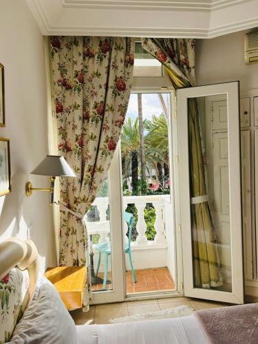 a room with a door open to a patio with a window at Hotel Plaza la marsa in Tunis