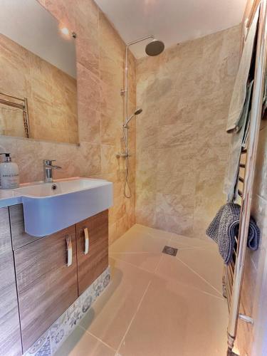 a bathroom with a sink and a shower at The lighthouse in St Ives