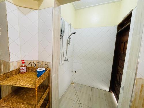 a bathroom with a shower and a sink at Giving Hands Homestay in Arusha