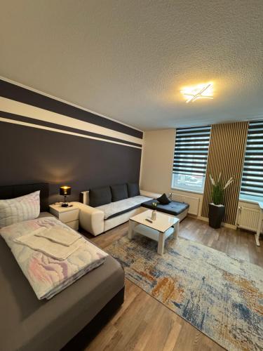 a living room with a bed and a couch at Ferienwohnung Florion 2 in Bernburg