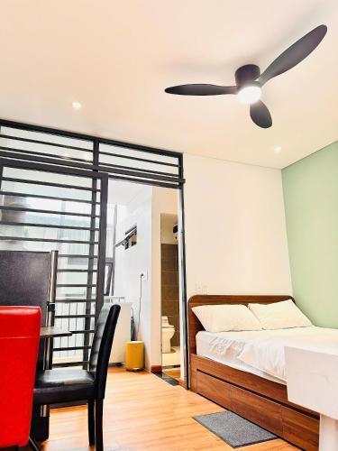 a bedroom with a bed and a ceiling fan at Happy House in Danang