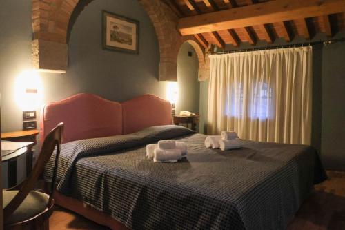 a bedroom with a bed with two towels on it at The Tower in Torreglia