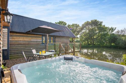 a hot tub in the backyard of a house at The Boathouse in Biddenden