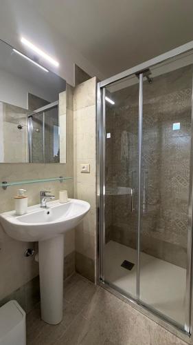 a bathroom with a sink and a shower at Albergo Cavour in Palermo