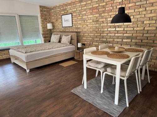 a bedroom with a bed and a table and chairs at Apartmani Petra Bezdan in Bezdan