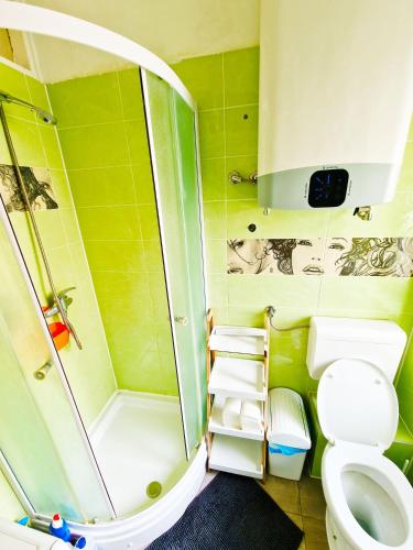 a small bathroom with a toilet and a shower at Croparadise Central in Split