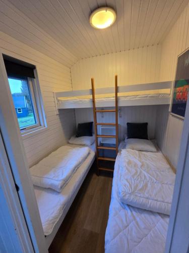 a room with two bunk beds in a house at Riis Feriepark in Give