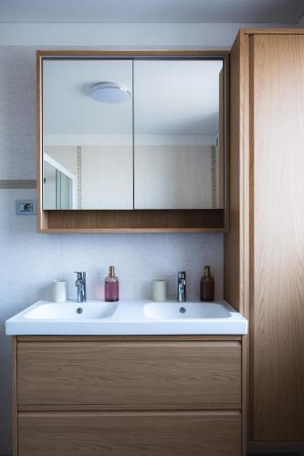 a bathroom with a white sink and a mirror at Villa Leo in Koper