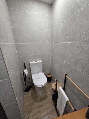 a bathroom with a white toilet in a room at Pátio do Tear in Sobreira Formosa