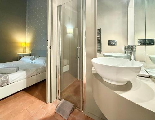 a bathroom with a sink and a shower and a bed at Serravalle Castle Apartment in Serravalle