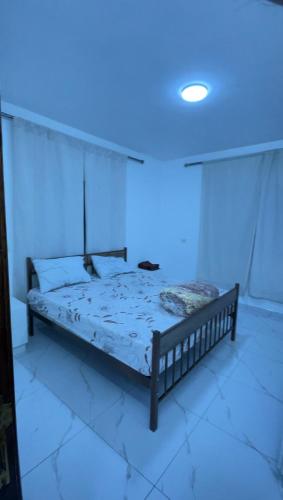 a bed in a room with a blue light at درة عبين الجناح الخاص in ‘Ibbīn