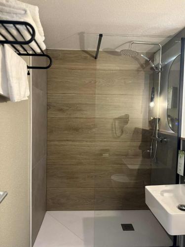 a bathroom with a shower with a toilet and a sink at Campanile NATURE -Haguenau in Haguenau
