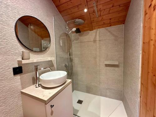a bathroom with a sink and a mirror at Chalet Ivoire in Durbuy
