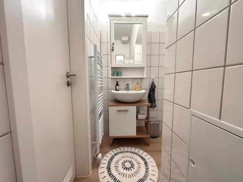 a bathroom with a sink and a mirror at Ferienwohnung MEERWEH in Fehmarn
