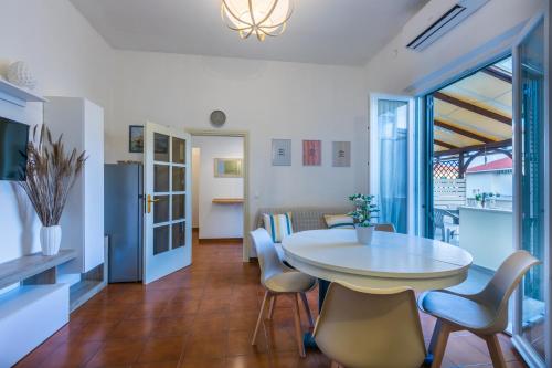 a kitchen and dining room with a table and chairs at Lido del Bardo in Marina di Cecina