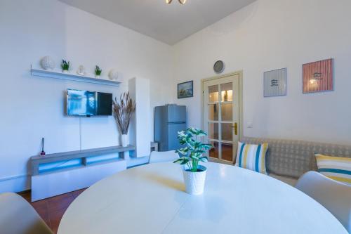 a living room with a white table with a potted plant at Lido del Bardo in Marina di Cecina