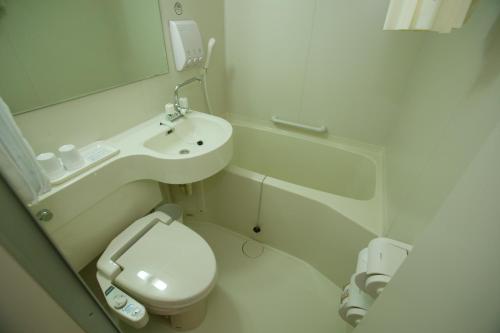 W łazience znajduje się umywalka, toaleta i lustro. w obiekcie Toyoko Inn Busan Station No.1 w Pusanie