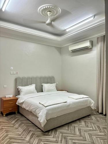 a bedroom with a large bed with a ceiling at BAIT AL-AFIA Hotel in Sur