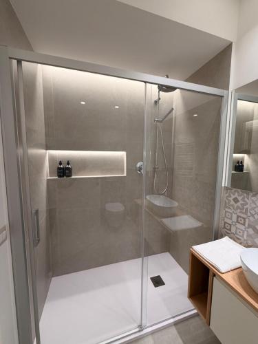 a glass shower in a bathroom with a sink at Da Nella 1 in Ancona