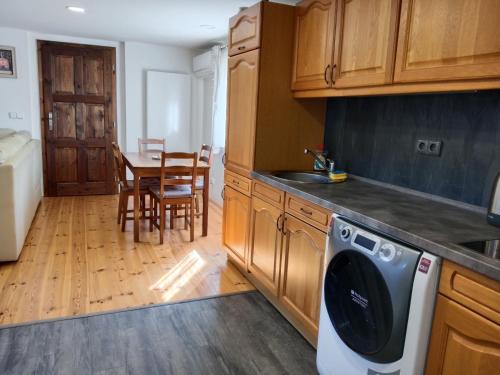 a kitchen with a dishwasher and a kitchen with a table at Chata Borecké skály in Ktová