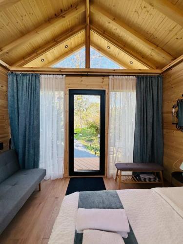 a bedroom with a bed and a large window at Garden rooms in Kutaisi in Kutaisi