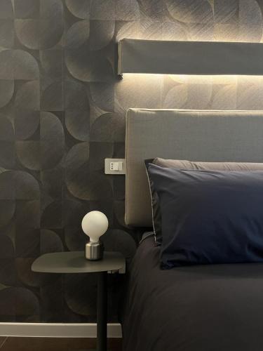 a bed with a nightstand next to a bed with a side table at Domus Europa in Matera