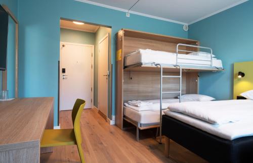 a room with two bunk beds and a desk at Thon Hotel Gardermoen in Gardermoen