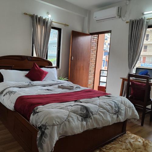 a bedroom with a bed and a large window at North face Studio in Pokhara