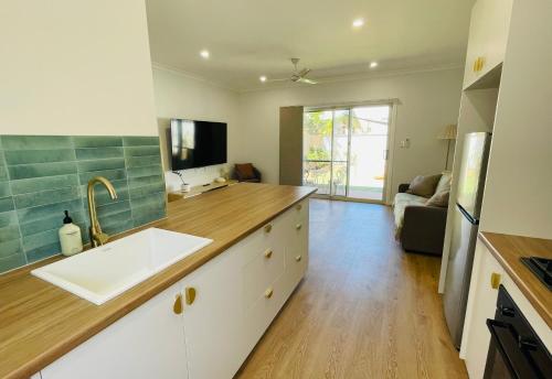 a kitchen with a sink and a counter top at Sunrise Beach Hideaway in Exmouth