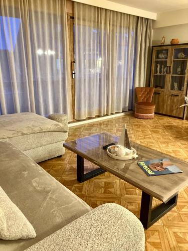 a living room with a couch and a coffee table at Sunshine centrum in Koksijde