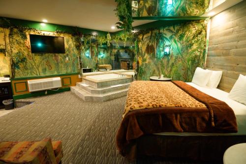 a hotel room with a bed and a bath tub at Inn of The Dove Romantic Luxury & Business Suites in Bensalem