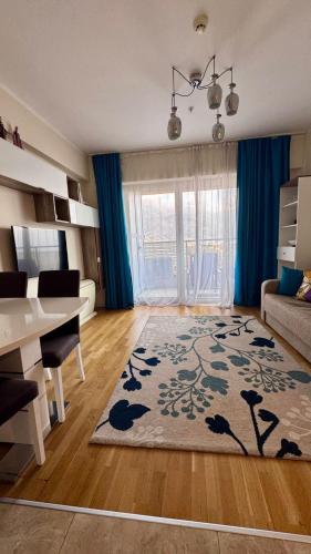 a living room with a table and a living room with a rug at Sea view apartment 2 in Boreti