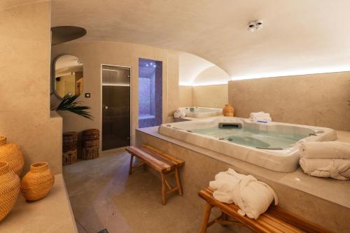 a large bathroom with a large tub with towels at Boutique Hotel Sablon by CW Hotel Collection in Bruges